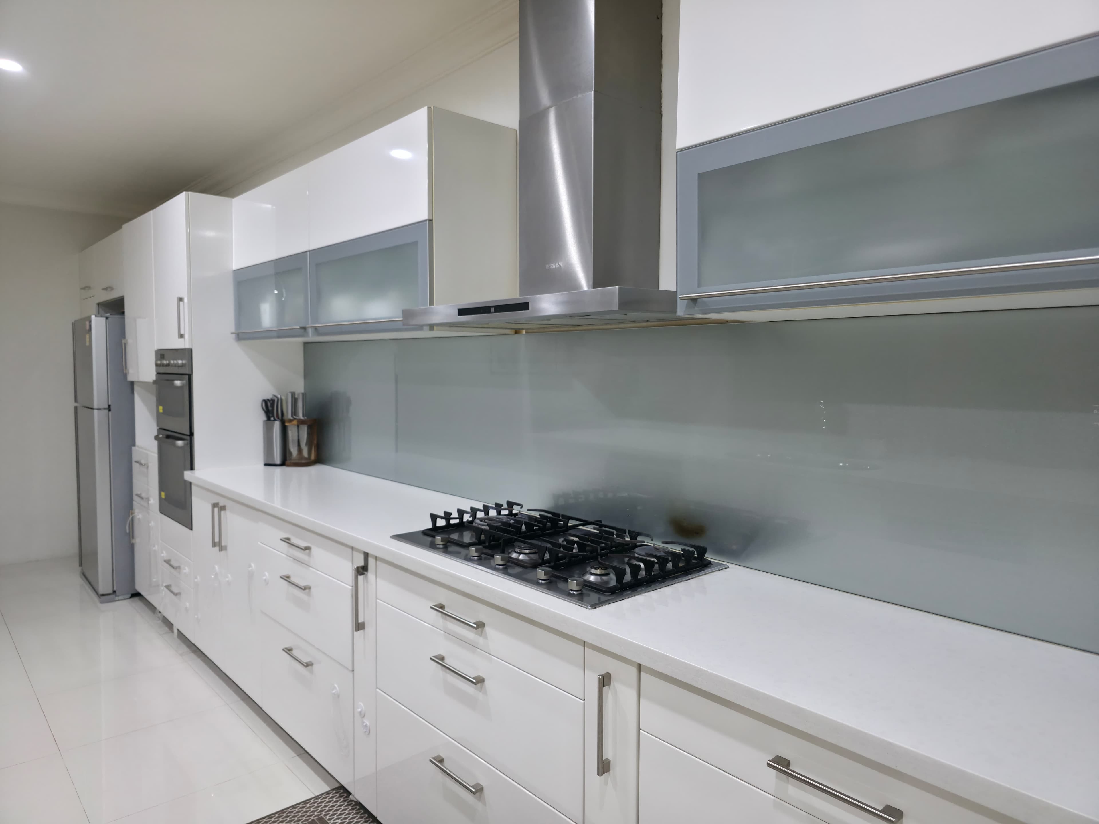 White kitchen with stone island bench